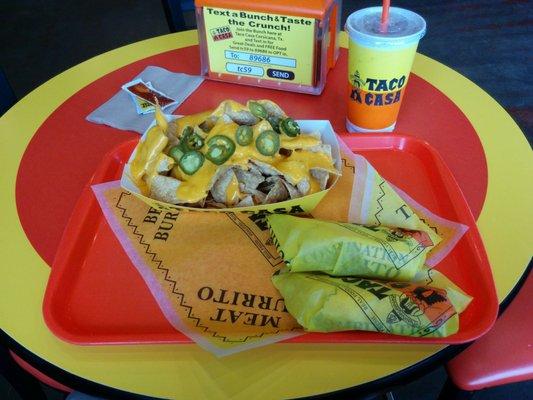 Two tacos, regular nachos with peppers, small drink.