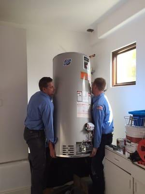 Here are 2 of our technicians installing a 75 gallon natural gas water heater made by Bradford White.