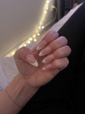 Gel X after two weeks still looks amazing!! Still completely solid- not lifting. French tip, almond shape -long.  Done by Ann