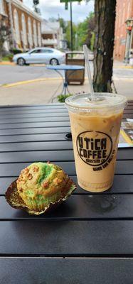 Pistachio muffin and iced coffee outside