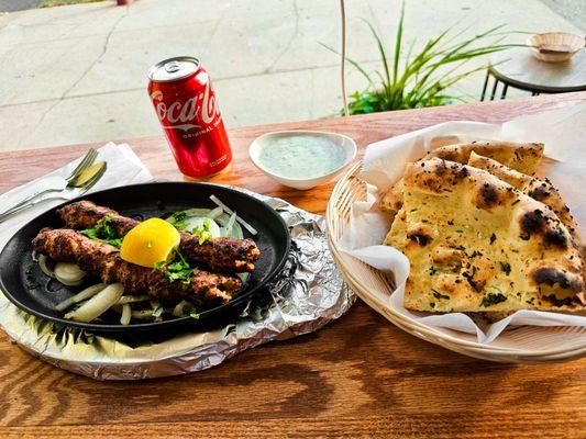 The ultimate trio: kebabs, naan, and Coke!