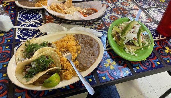 1 Chicharron Taco, 1 Bistec Taco, and Rice and Beans. The dish on the right was a Sopes.