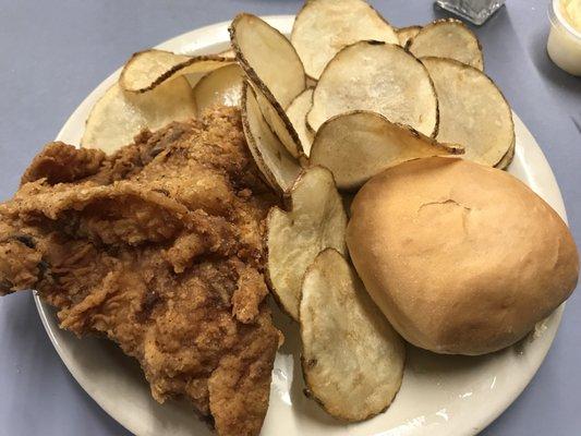 Fried chicken and home fries with a roll