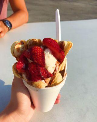 The bubble waffle with vanilla icecream, strawberries, and chocolate sauce!