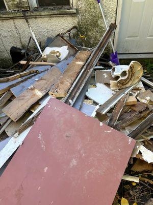 Demo debris thrown outside by client's contractor.
We were called to haul it all !