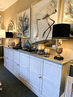 Large neutral decorative cabinet styled with eclectic accessories and art at Patrick Day Home Gallery.