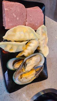 Some hot pot toppings: Spam, gyoza and mussels