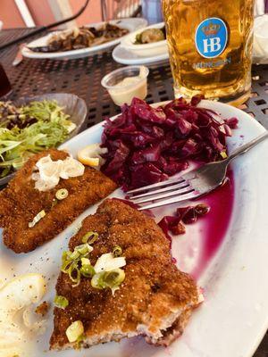 Slabs of schnitzel, red cabbage, potato salad and ice cold beer with no head