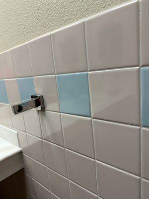 Broken towel rack in restroom