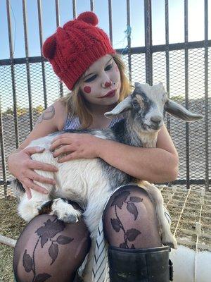 Volunteer coordinator and clown squad member tending to the goat