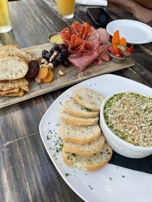 Charcuterie board and spinach artichoke dip