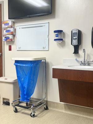 The linen cart and next to the sink.  This is AFTER  I moved the cart.  This is where the PA-C placed a STERILE field for sutures.