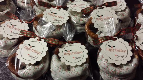 Pretzels dipped in caramel and white chocolate.  Holiday party favors