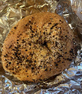 Flat bagel. Flat whole wheat everything bagel