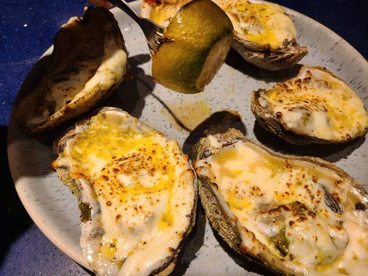 Grilled oysters are huge right now. Lime slice held up for scale.