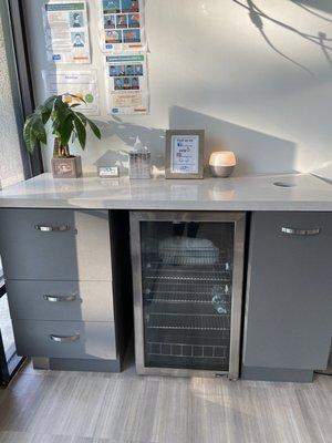 It's empty now, but this mini fridge is full of FULL SIZED complimentary water bottles for their patients!