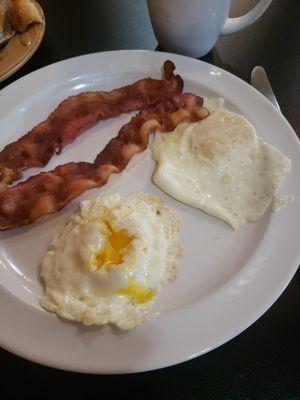 Two eggs and bacon cooked just perfect. Delicious coffee, what a blessed way to start your morning!