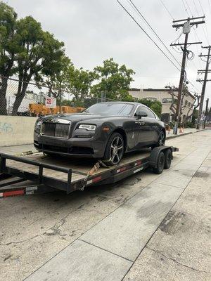 The vehicle on the trailer to be transported to our special event missing front parts on the vehicle.