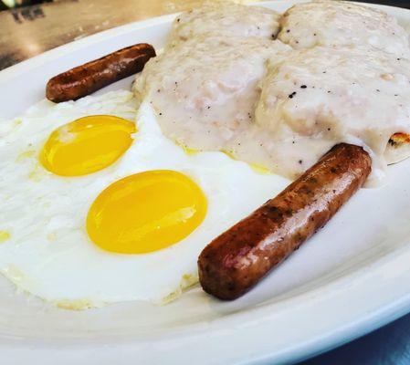 Biscuits & Gravy Combo, Fluffy Biscuits topped with homemade sausage gravy, comes with choice of egg style, and choice, Bacon, or Sausage.