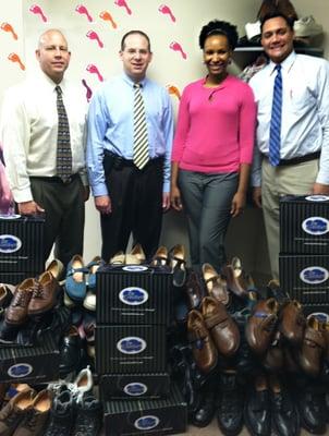 The docs at WeTreatFeet pose with donated shoes for the homeless