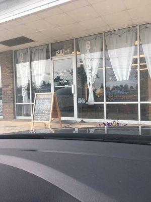 Front door with entry sign and one of the two menus visible. Taken from inside our car.