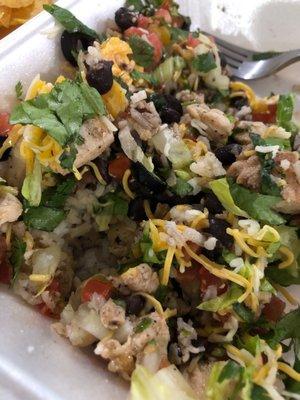 Chicken bowl with rice, black beans, lettuce, cheese, pico, cilantro and black olives