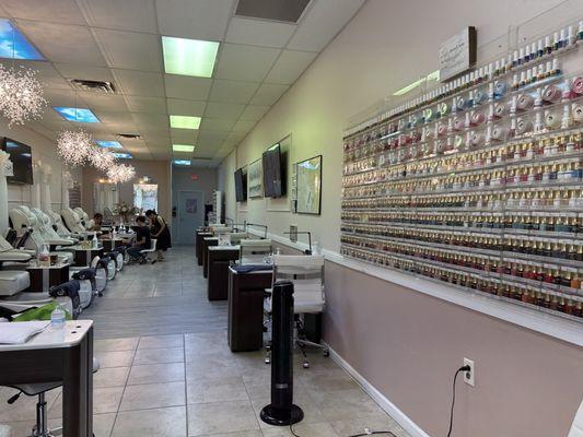 The different pedicure stations and just half of the colors available on the wall.