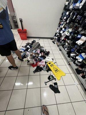 Merchandise on the floor in a pile on the checkout line