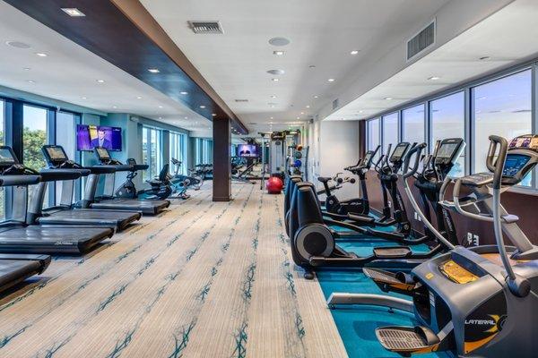 Fitness center with cardio and strength training equipment.