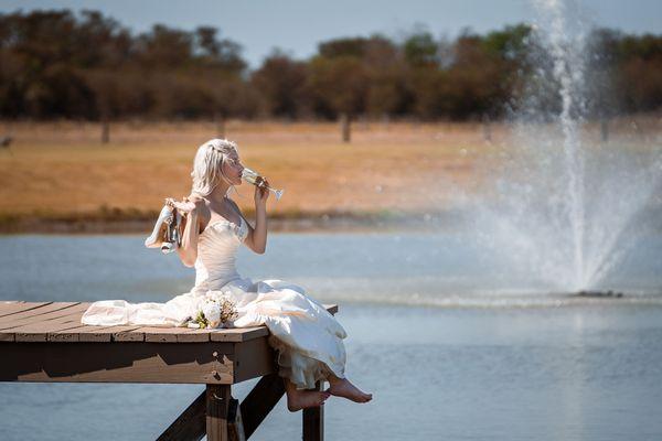 Bride takes a sip of champagne and enjoys the afternoon