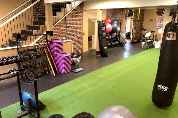 Turf room loaded with equipment and punching bags