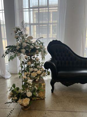 Floral decorations and unique couch infront of windows