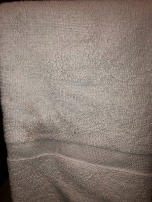 Red stain on bathroom towel.