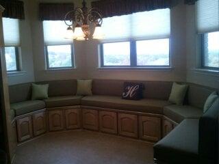 Octagon seating in a breakfast area. We added comfort and warmth to the seating area by custom cushions and back rests.