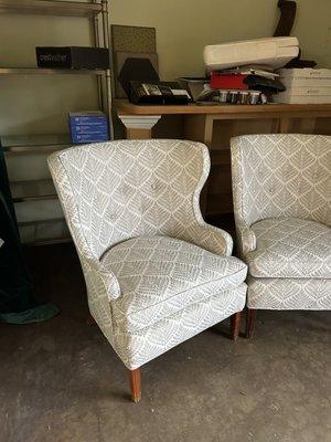 Two new wing back chairs, upholstered in custom on fabric