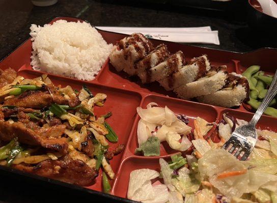 Lunch box spicy Korean pork and shrimp tempura rolls.