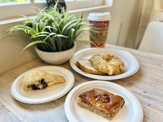 Cheese Bagel with cream cheese, lemon blueberry scone, baklava and a latte