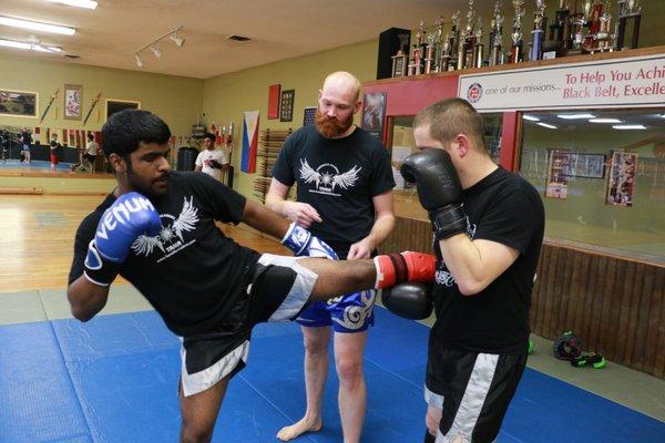 Certified Muay Thai instructor Seth correct students Muay Thai techniques