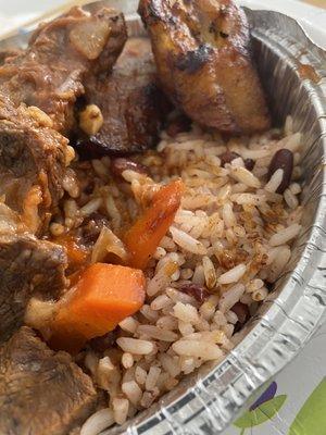 Rice and peas buried under the tender stew beef