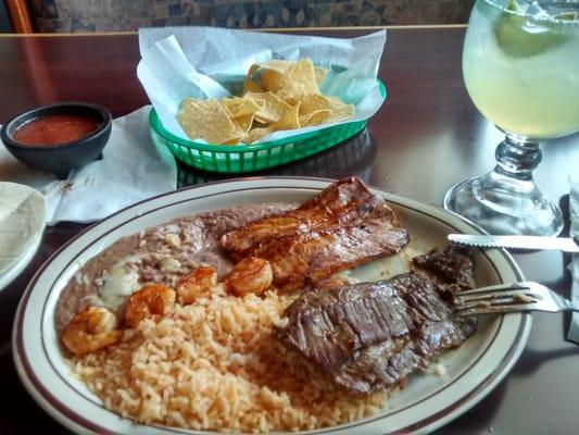 Skirt steak, chicken, shrimp with beans and rice and tortillas. So good...