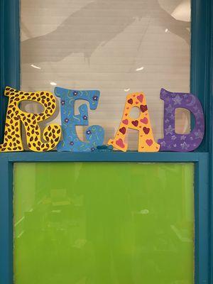 Colorful sign in our storytime room.