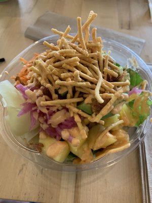 Made to order Poke bowl with tuna, pineapple, carrots, cucumber, sweet corn, pickled red onion, sriracha aioli sauce, on baby kale.