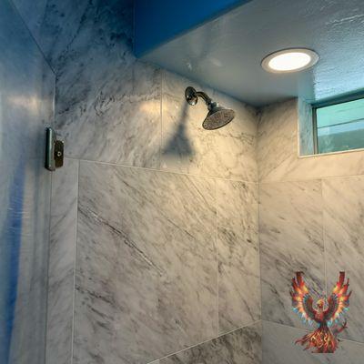 Upgrade your daily routine with a sleek and modern showerhead, seamlessly integrated into your remodeled bathroom.