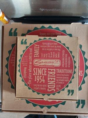 pizza boxes, family sized topped with a small