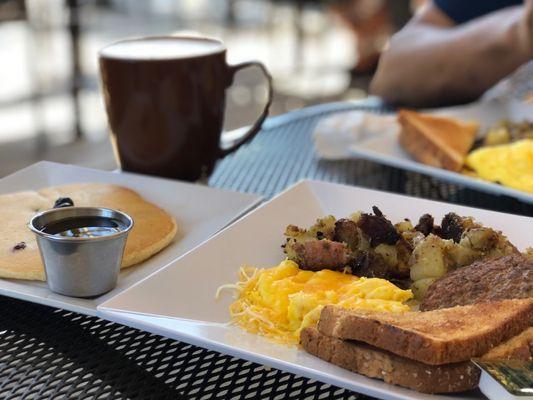 One blueberry pancake, scrambled eggs w/ cheese on top, red potatoes, turkey sausage, toast with large mint chocolate frappe