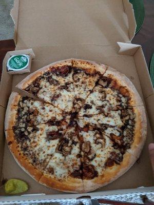 Cheese pizza with BBQ sauce and mushroom toppings. It comes with garlic sauce and pepperoncini.