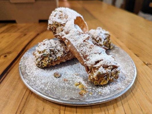 Cannoli. 2 for $7.50. Filled with candied orange, chocolate, and pistachios.