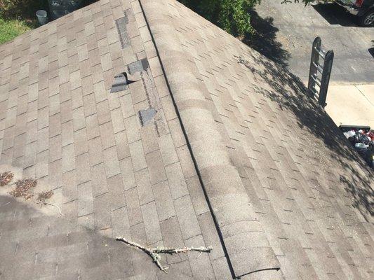 Before - Visible damage and missing shingles.