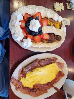 Hungry man with French toast with fruit and whip