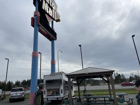 The truck under the large auto mall sign